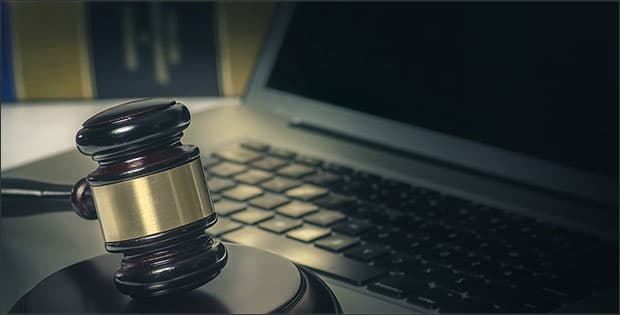 Law gavel and computer depicting doxxing