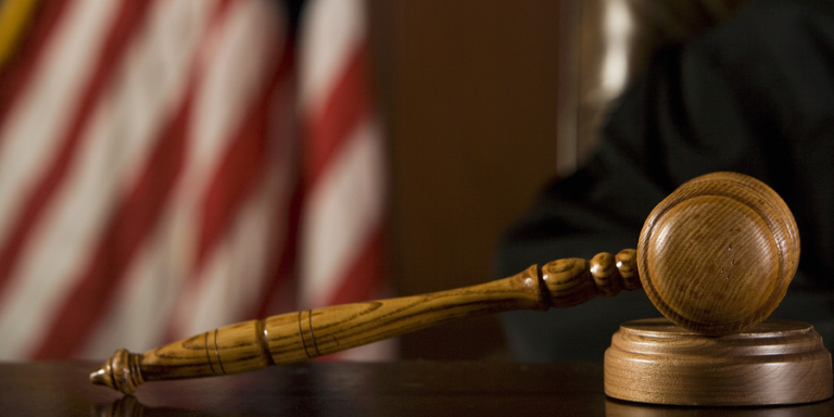 American flag and gavel depicting federal charges - fake resume