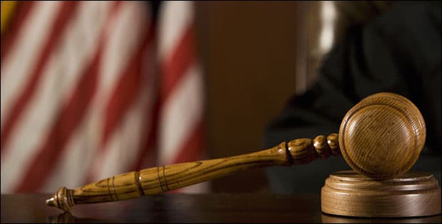 American flag and gavel depicting federal charges - fake resume