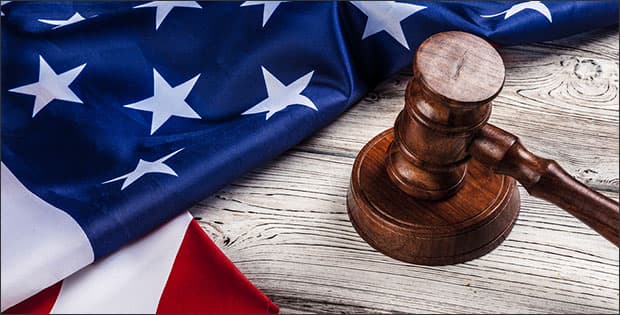 American flag and gavel depicting immunity in a federal case