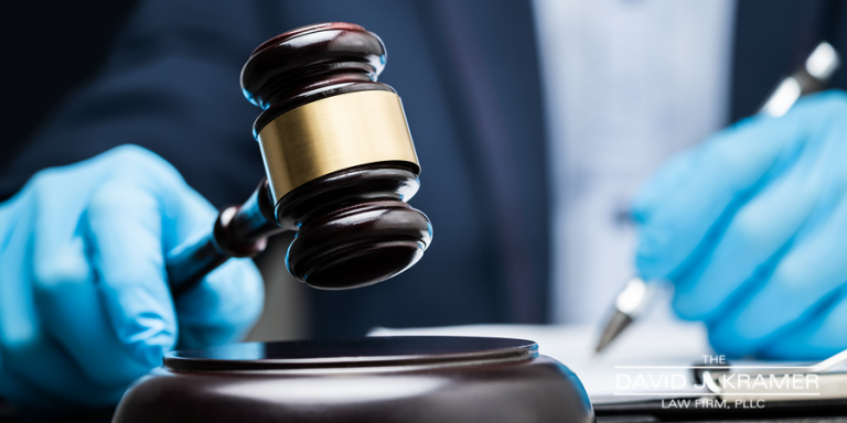 Judge holding gavel with gloves on depicting price gouging charges