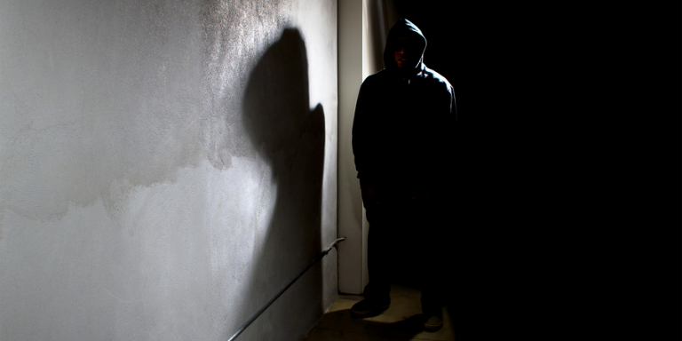 Man in shadows stalking